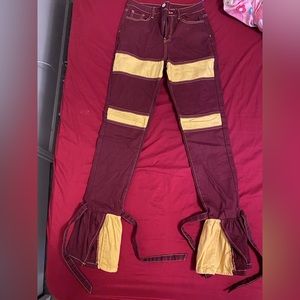 Burgundy and yellow hem jeans .